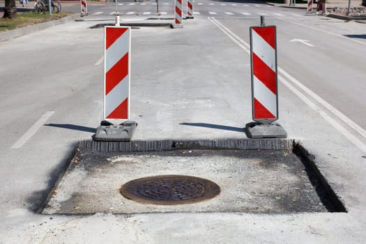 street repair, new asphalt with sewage wells