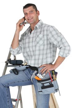 Carpenter posing by ladder