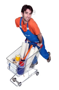 Painter with utensils in shopping cart