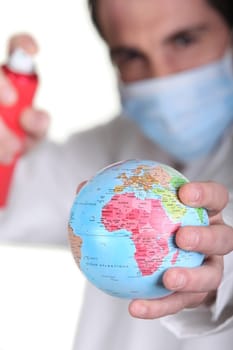 Doctor holding miniature globe