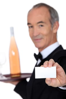 Wine steward showing a business card