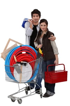 Couple with trolley full of DIY equipment