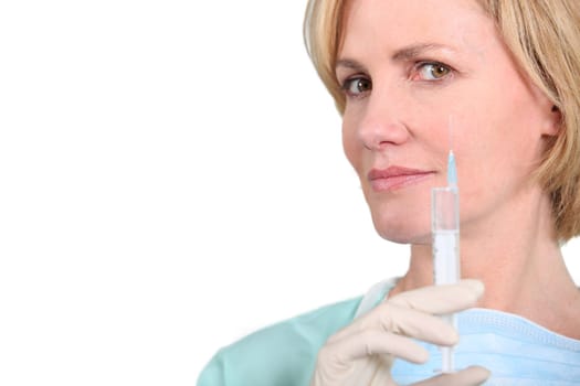Female medic with a syringe