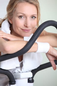 Woman using cycling machine to stay fit