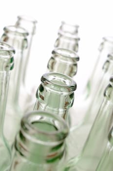 Empty bottles on a white background, selective focus on foreground
