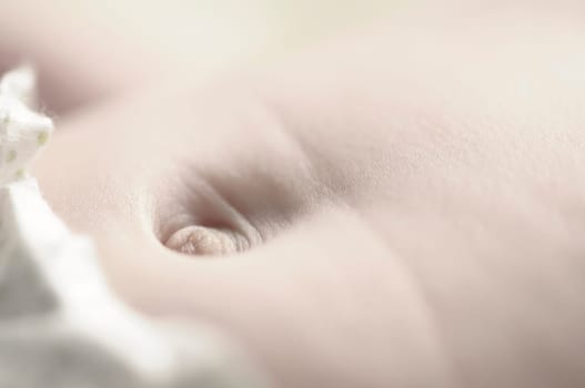 Close up of baby girls' sweet little bellybutton