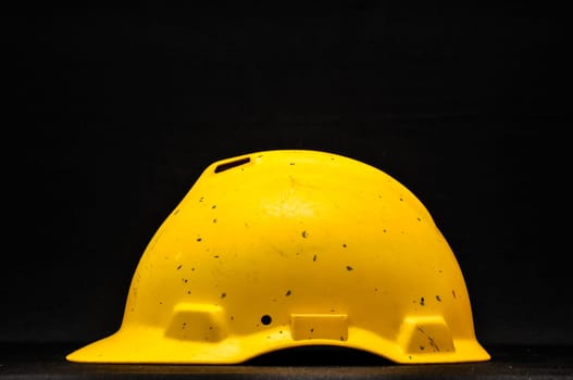 Yellow Safety Helmet on a Black Background