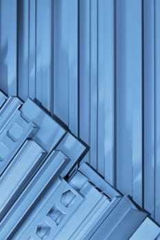many different aluminium profile strips in blue light
