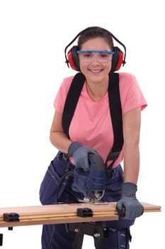 Woman using an electric jigsaw