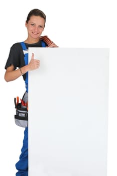 Woman with blank board, toolbox and thumbs up