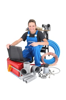 Female plumber with equipment, studio shot