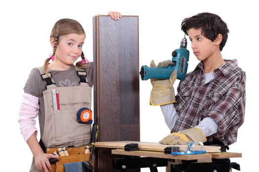 Little boy and girl with power tools