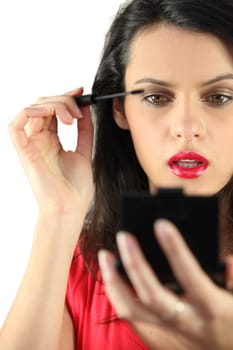 Woman applying mascara
