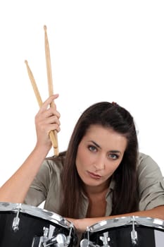 female musician posing with drums
