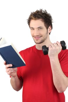 Man reading book whilst lifting weights