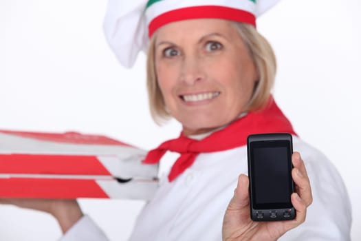 mature female pizza cook showing a cell phone