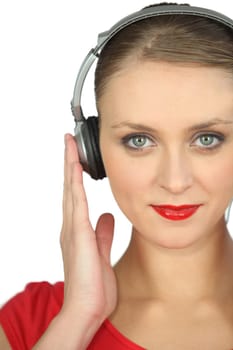 Close-up shot of a woman listening to music