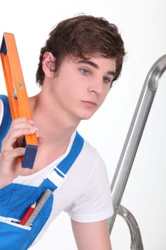 Apprentice workman with a spirit level