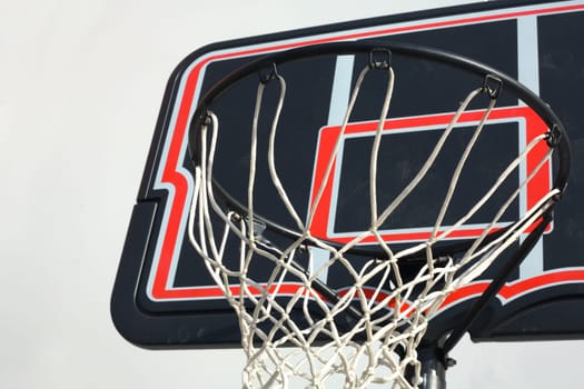 Black and red basketball hoop isolated over white blackground