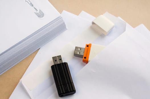 Stack of white envelopes and USB flash memory drives as concept