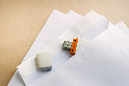 Stack of white envelopes and USB flash memory drives as concept