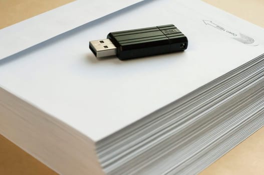 Stack of white envelopes and USB flash memory drive as concept