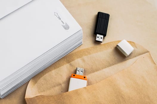 Stack of white envelopes and USB flash memory drives as concept