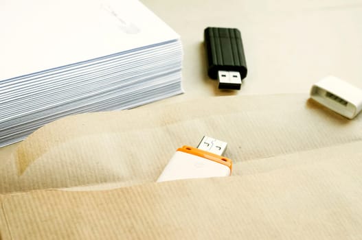 Stack of white envelopes and USB flash memory drives as concept