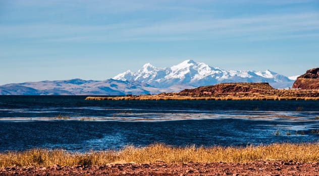 Lake Titicaca from the bolivian side. The lake is located at the northern end of the endorheic Altiplano basin high in the Andes on the border of Peru and Bolivia. The western part of the lake lies within the Puno Region of Peru, and the eastern side is located in the Bolivian La Paz Department.The lake is composed of two nearly separate sub-basins that are connected by the Strait of Tiquina which is 800 m (2,620 ft) across at the narrowest point. The larger sub-basin, Lago Grande (also called Lago Chucuito) has a mean depth of 135 m (443 ft) and a maximum depth of 284 m (932 ft). The smaller sub-basin, Winaymarka (also called Lago Pequeno, "little lake"") has a mean depth of 9 m (30 ft) and a maximum depth of 40 m (131 ft).The overall average depth of the lake is 107 m (351 ft)"