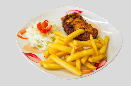 White plate with floral pattern on it a schnitzel with fries and salad against a white background