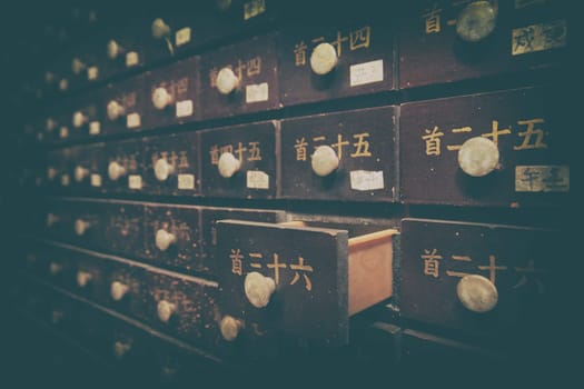 Numbered brown wooden cases in the interior of Chinese temple