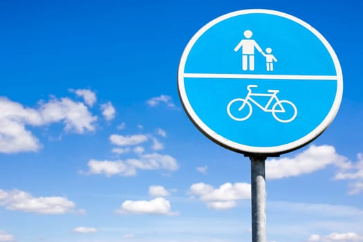 Bicycle and pedestrian shared route sign on the sky background
