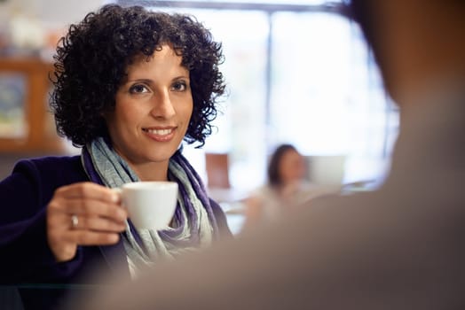 People in cafeteria with woman drinking espresso coffee and holding cup