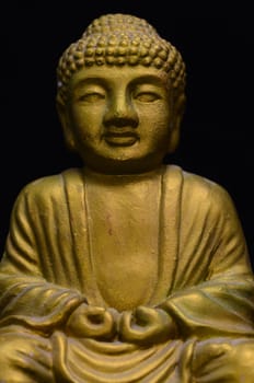 Golden Buddha Statue on a Black Background