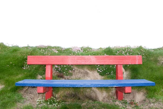 red and blue bench positioned at the edge on top of a cliff