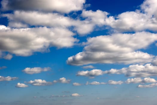 white fluffy clouds on a bright blue day