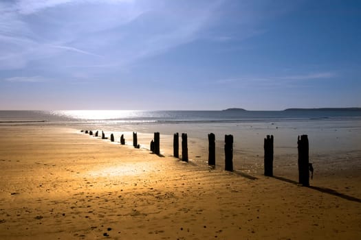 sunshine over the beach breakers in Youghal county Cork Ireland on a summers day