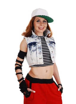 A hip hop woman in red pants, jeans jacket and a hat standing.isolated on white background..