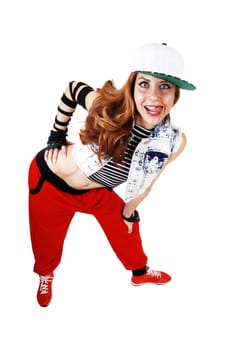 A lovely woman in red pants, jeans jacket and a hat standing bend.forwards isolated on white background..