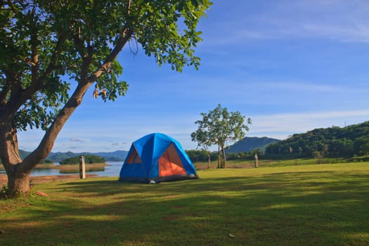 Camping in the wilderness, tent on campground in morning