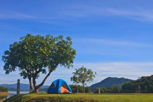 Camping in the wilderness, tent on campground in morning