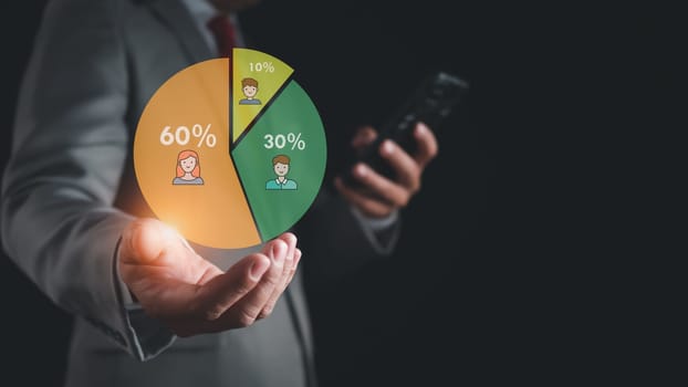 Businessman holds a chart to represent business target group management. Lead, buyer, customer behavior concept Marketing plans and strategies Personal marketing Customer-centric strategy