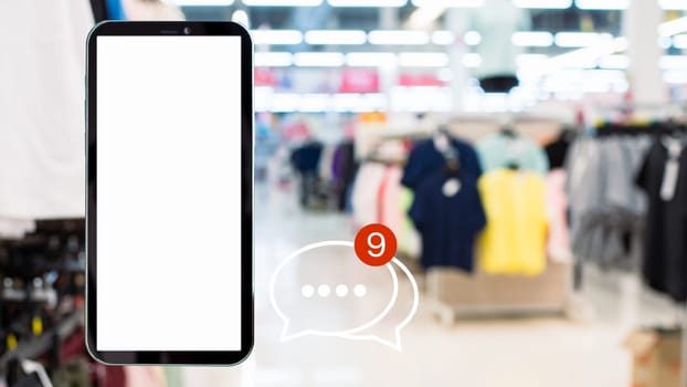 White screen smartphone with message icons isolated on background inside shopping mall. online shopping Website, marketplace platform, e-commerce technology and online payment concepts.