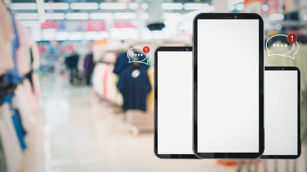 White screen smartphone with message icons isolated on background inside shopping mall. online shopping Website, marketplace platform, e-commerce technology and online payment concepts.