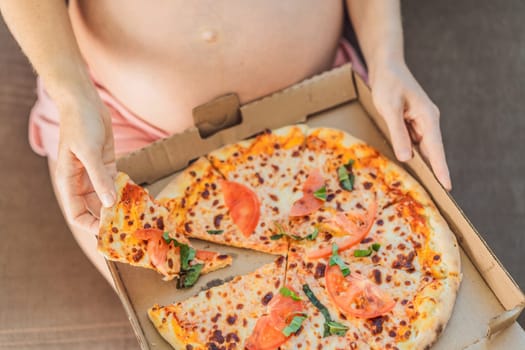 A pregnant woman enjoys a slice of pizza, savoring a moment of indulgence while satisfying her craving for a delightful, comforting treat. Excited Pregnant Young Lady Enjoying Pizza Holding Biting Tasty Slice Posing With Carton Box. Junk Food Lover Eating Italian Pizza. Unhealthy Nutrition Cheat Meal.