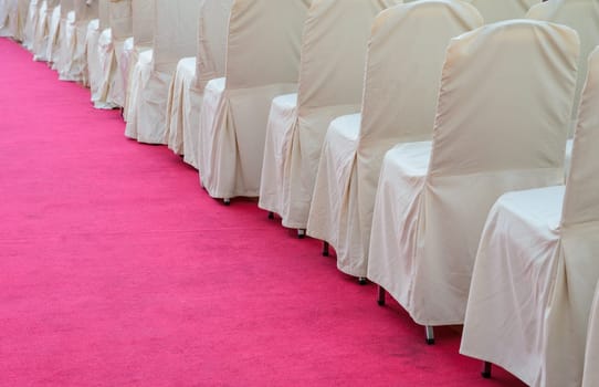 Fabric chairs on red carpet