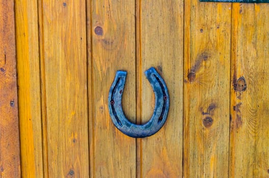 Old horseshoe screwed on a wooden board as a lucky charm
