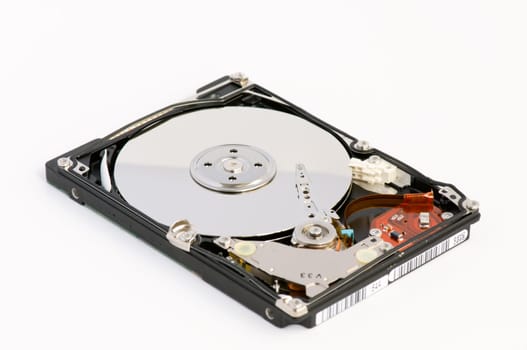 Opened hard disk showing the disk surface and drive head