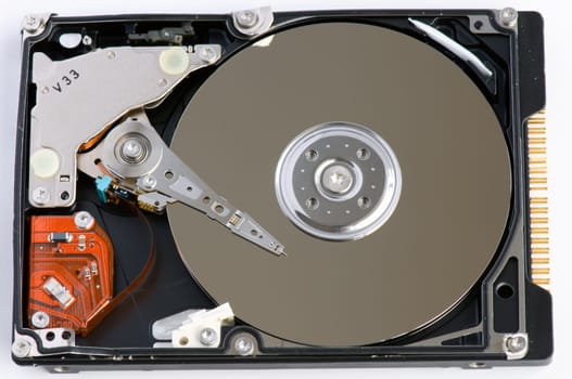 Opened hard disk showing the disk surface and drive head