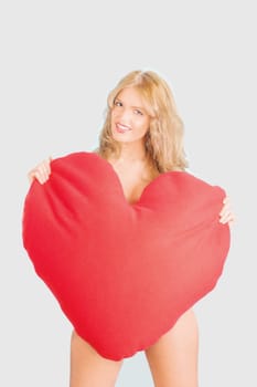 beautiful woman holding heart shaped cushion